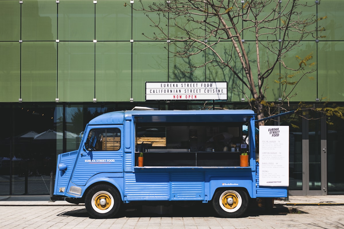 Colorful food truck serving customers at a busy street location
